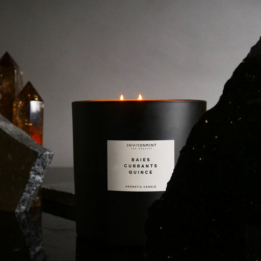 Luxury scented candle in a glass vessel styled for a refined home setting