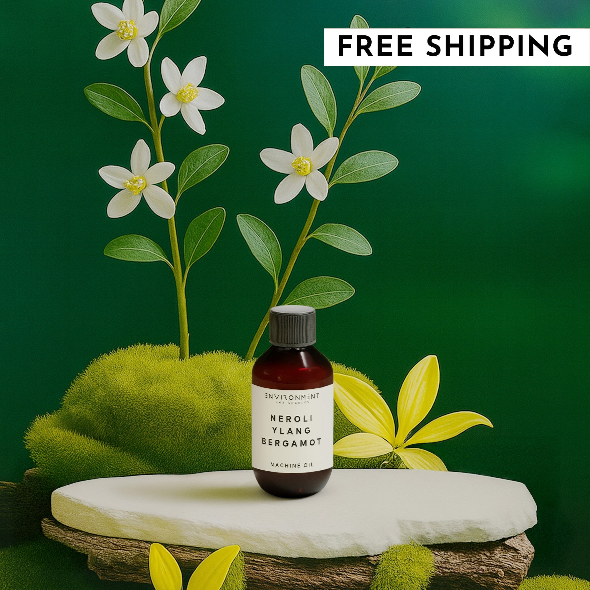 Bottle of 'Neroli Ylang Bergamot' oil with flowers and greenery on a dark green background