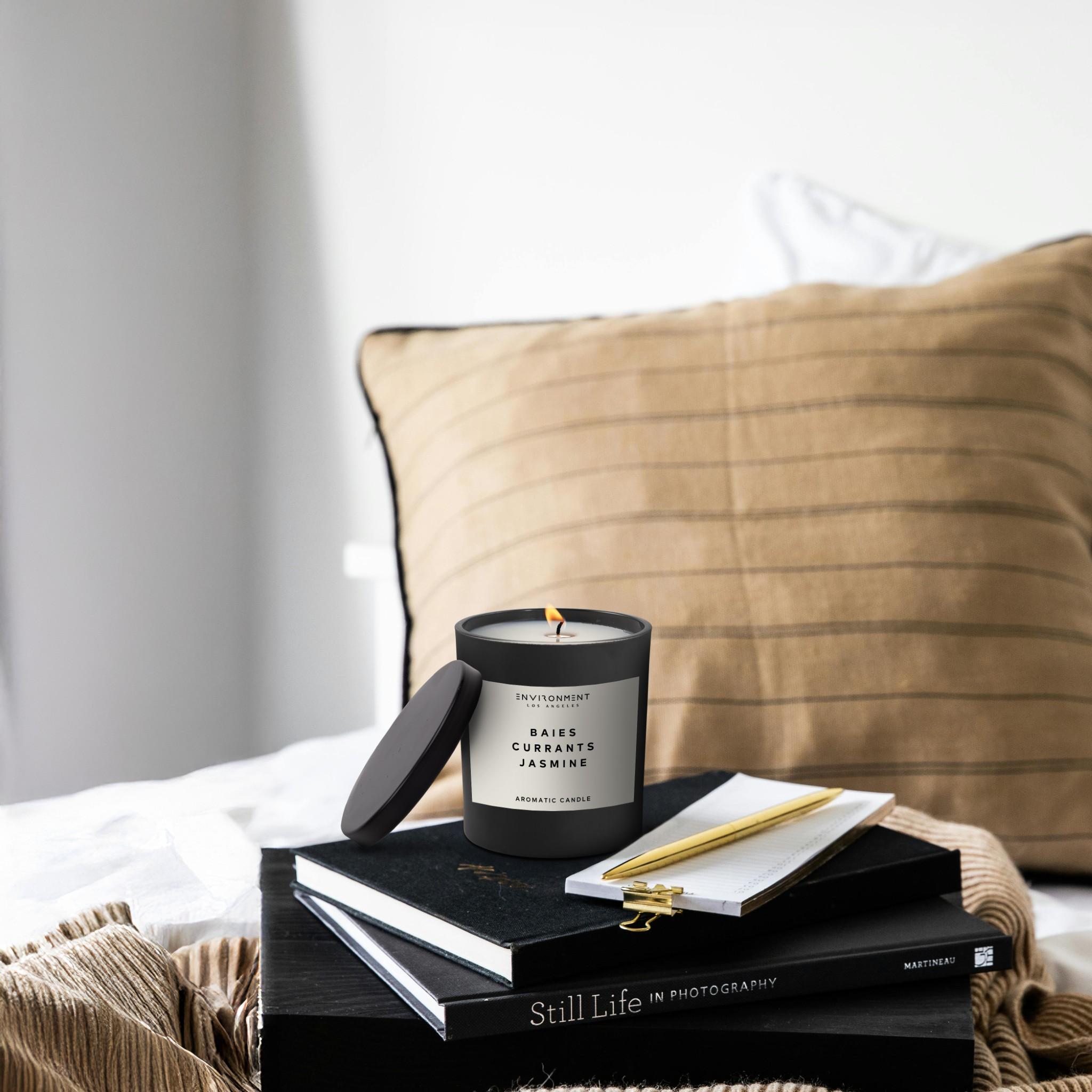 Baies Candle on top of books